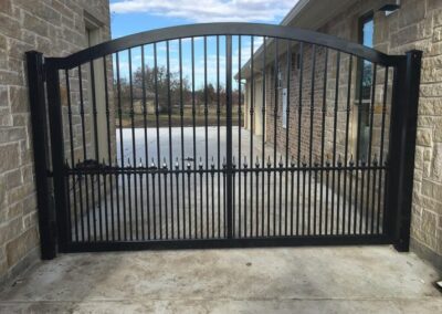 Expertly Installed Custom Iron Drive Gate by Spring Creek Fence and Gate
