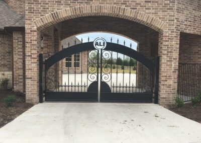 Elegant iron driveway gate by Spring Creek Fence and Gate - Expert craftsmanship.